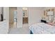 Well-lit bedroom showcasing an open doorway to an ensuite bathroom and view into a living space at 210 Maycrest Path, Tucker, GA 30084