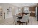 An open dining area features a modern table set with decorative place settings and stylish light fixtures at 210 Maycrest Path, Tucker, GA 30084