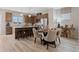 Open-concept kitchen and dining area with an island, bar stools and an elegant table setting at 210 Maycrest Path, Tucker, GA 30084