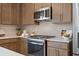 Modern kitchen showcasing stainless steel appliances, light countertops, and stylish backsplash at 210 Maycrest Path, Tucker, GA 30084