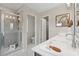A bright main bathroom includes a glass-enclosed shower, modern fixtures, and vanity with decor at 210 Maycrest Path, Tucker, GA 30084