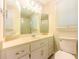 This is a bathroom featuring a tile floor, white vanity, large mirror, and shower stall at 5841 Covered Wagon Trl, Lilburn, GA 30047