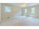 This bedroom features carpet flooring, a ceiling fan, and natural light streaming through the windows at 5841 Covered Wagon Trl, Lilburn, GA 30047