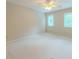 This bedroom features carpet flooring, a ceiling fan, and natural light from the windows at 5841 Covered Wagon Trl, Lilburn, GA 30047
