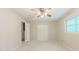 This is a bedroom featuring carpet floors, a ceiling fan, and natural light from the window at 5841 Covered Wagon Trl, Lilburn, GA 30047