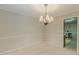 Traditional dining room with chair rail and a stylish chandelier at 5841 Covered Wagon Trl, Lilburn, GA 30047