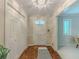 Well-lit foyer with parquet floors, coat closet, and view into the living area at 5841 Covered Wagon Trl, Lilburn, GA 30047