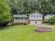 Well-maintained home with front yard, two car garage, and covered porch at 5841 Covered Wagon Trl, Lilburn, GA 30047