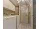Functional laundry room featuring a washer, dryer, and storage cabinets at 5841 Covered Wagon Trl, Lilburn, GA 30047