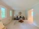 Bright living room with large windows, soft carpet, and comfortable seating, great for entertaining at 5841 Covered Wagon Trl, Lilburn, GA 30047