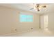 Bedroom with neutral walls, a window, and view into the bathroom at 5841 Covered Wagon Trl, Lilburn, GA 30047