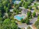 An aerial view showing a pool and clubhouse complex nestled in the middle of a lush green community at 5875 Windjammer Pt, Cumming, GA 30041