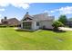 Well-maintained lawn, patio, and bright sunroom on this home's backyard at 5875 Windjammer Pt, Cumming, GA 30041