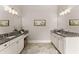 This bathroom features dual sinks, granite countertops, and white cabinets at 5875 Windjammer Pt, Cumming, GA 30041