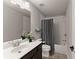 Bathroom featuring a shower/tub combo and dark wood vanity at 5875 Windjammer Pt, Cumming, GA 30041