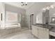 This bathroom has granite countertops, a glass enclosed shower, and a soaking tub at 5875 Windjammer Pt, Cumming, GA 30041