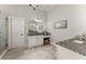 Bathroom with granite counters, dual vanities, and tile floors at 5875 Windjammer Pt, Cumming, GA 30041