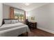 A cozy bedroom has hardwood floors, a modern ceiling fan and a beautiful wood desk at 5875 Windjammer Pt, Cumming, GA 30041