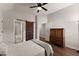 Comfortable bedroom featuring a sliding barn door to an ensuite bathroom at 5875 Windjammer Pt, Cumming, GA 30041