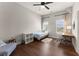 This bedroom features hardwood floors, two windows, and a ceiling fan at 5875 Windjammer Pt, Cumming, GA 30041