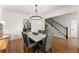 Elegant dining room boasting hardwood floors, modern chandelier, and view of the staircase at 5875 Windjammer Pt, Cumming, GA 30041