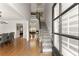 Inviting entryway featuring hardwood floors and a staircase, complemented by natural light through the glass-paneled front door at 5875 Windjammer Pt, Cumming, GA 30041