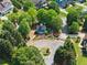 Community entrance with manicured landscaping, a sign and stone pillars and iron gate at 5875 Windjammer Pt, Cumming, GA 30041
