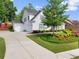 Charming two-story house features an attached two-car garage and a beautifully landscaped front yard at 5875 Windjammer Pt, Cumming, GA 30041