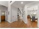 Inviting foyer with hardwood floors, staircase, and view into the dining room at 5875 Windjammer Pt, Cumming, GA 30041
