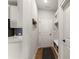 Hallway features coat racks, modern lighting, and a convenient bench with storage underneath at 5875 Windjammer Pt, Cumming, GA 30041
