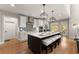 Modern kitchen with a large island, stainless steel appliances, and bar stool seating at 5875 Windjammer Pt, Cumming, GA 30041
