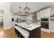 Spacious kitchen featuring a large island with seating, stainless steel appliances, and white cabinetry at 5875 Windjammer Pt, Cumming, GA 30041
