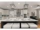 Modern kitchen features a white island with seating, pendant lighting, and stainless steel appliances at 5875 Windjammer Pt, Cumming, GA 30041