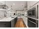Bright open kitchen features a large island with seating and stainless steel appliances at 5875 Windjammer Pt, Cumming, GA 30041