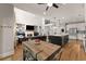 Open concept kitchen and living room with hardwood floors and lots of natural light at 5875 Windjammer Pt, Cumming, GA 30041