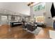Open concept living area with kitchen island and large windows providing ample natural light at 5875 Windjammer Pt, Cumming, GA 30041