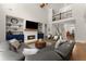 Spacious living room with a fireplace, built-in shelving, and an open view of the staircase at 5875 Windjammer Pt, Cumming, GA 30041