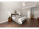 Calming main bedroom featuring tray ceiling and gleaming hardwood floors at 5875 Windjammer Pt, Cumming, GA 30041