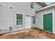 Backyard view showing the exterior of the home with an outdoor patio and green door at 8541 Westchester Dr, Douglasville, GA 30134
