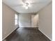 Comfortable bedroom with neutral carpet, ceiling fan, and bright natural light from the window at 8541 Westchester Dr, Douglasville, GA 30134