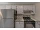 Well-equipped kitchen with stainless steel refrigerator, oven, granite countertops, and modern cabinets at 8541 Westchester Dr, Douglasville, GA 30134