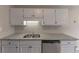 Kitchen with stainless steel appliances, granite counters, and ample storage space in white cabinets at 8541 Westchester Dr, Douglasville, GA 30134