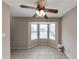 Bright living area featuring tiled floors, bay window and a ceiling fan, providing ample natural light at 8541 Westchester Dr, Douglasville, GA 30134