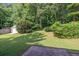Lush backyard featuring mature trees and green grass at 103 Sir Gregory Nw Mnr, Lawrenceville, GA 30044