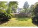Spacious backyard featuring a well-maintained lawn, mature trees, and a patio area perfect for outdoor living at 103 Sir Gregory Nw Mnr, Lawrenceville, GA 30044