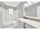 Stylish bathroom featuring tiled floors, sleek vanity, and a bathtub with shower at 103 Sir Gregory Nw Mnr, Lawrenceville, GA 30044