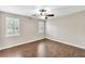 Large bedroom featuring hardwood floors and two shuttered windows at 103 Sir Gregory Nw Mnr, Lawrenceville, GA 30044