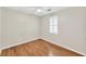 Bedroom featuring bamboo floors, a ceiling fan, and shuttered window at 103 Sir Gregory Nw Mnr, Lawrenceville, GA 30044