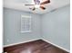 Cozy bedroom with hardwood floors, ceiling fan, and natural light from window at 103 Sir Gregory Nw Mnr, Lawrenceville, GA 30044