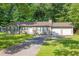 Traditional home featuring a two-car garage, dark shutters and green grass at 103 Sir Gregory Nw Mnr, Lawrenceville, GA 30044